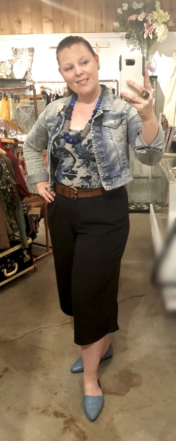 Jean jacket and black capri trousers for a business casual look.